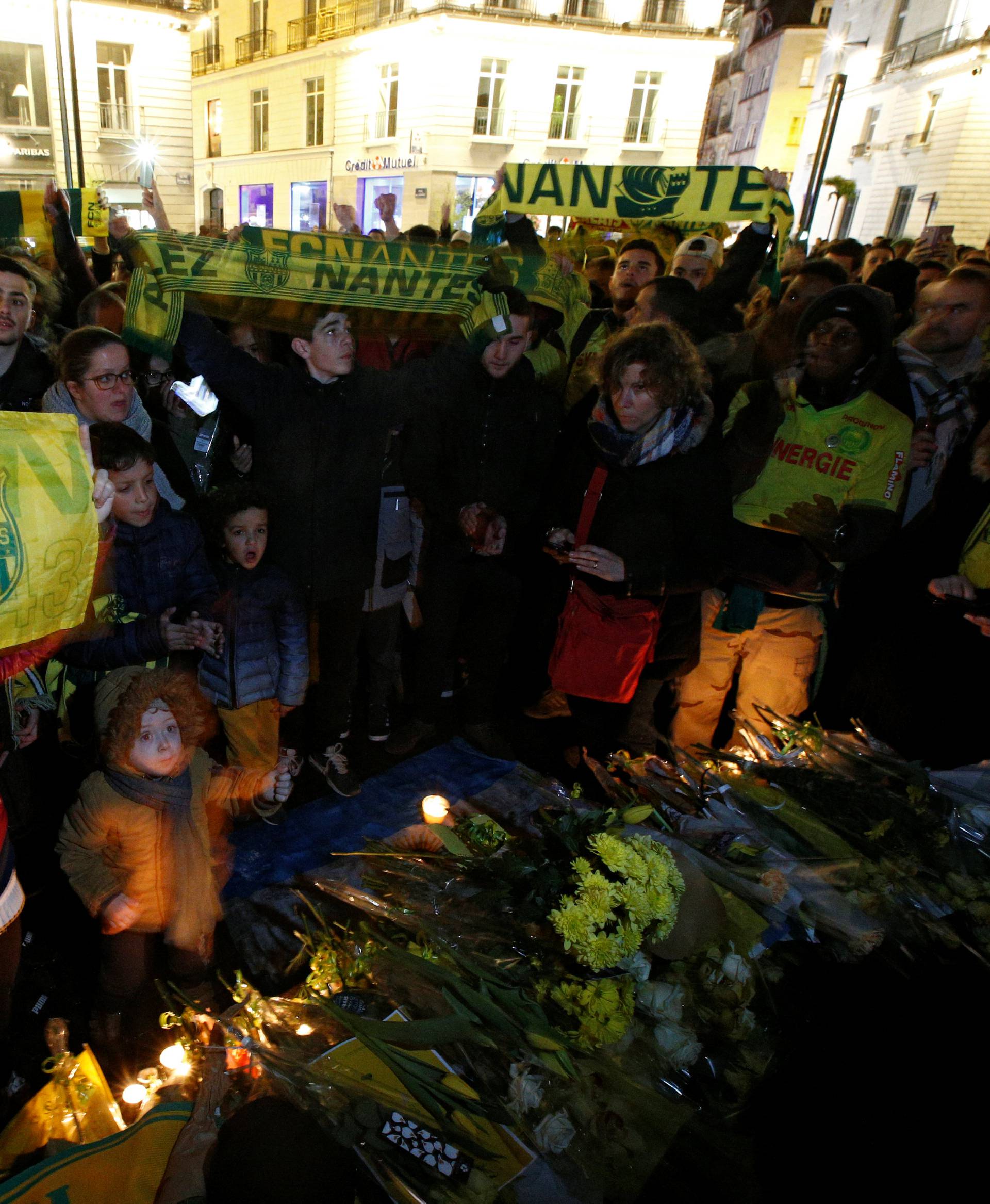 Fans gather near a row of yellow tulips in Nantes' city center after news that newly-signed Cardiff City soccer player Emiliano Sala was missing after the light aircraft he was travelling in disappeared between France and England