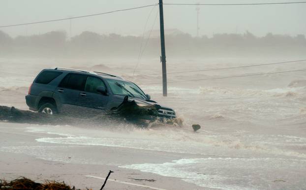 A car is surrounded by floodwaters from Hurricane Harvey in Point Comfort