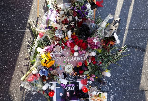 Flowers and pictures are placed on the star of late Ozzy Osbourne at the Hollywood Walk of Fame in Los Angeles