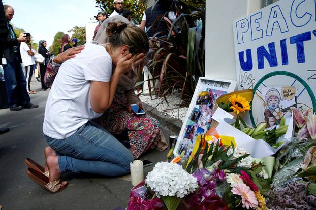 A woman reacts at a make shift memorial outside the Al-Noor mosque in Christchurch