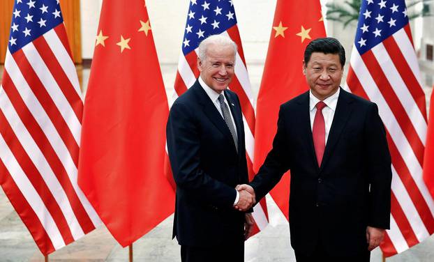 FILE PHOTO: Chinese President Xi Jinping shakes hands with U.S. Vice President Joe Biden inside the Great Hall of the People in Beijing