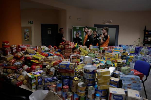 A volunteer and members of Civil Protection prepare donations to be sent by truck to victims of flooding in Valencia, in Ronda