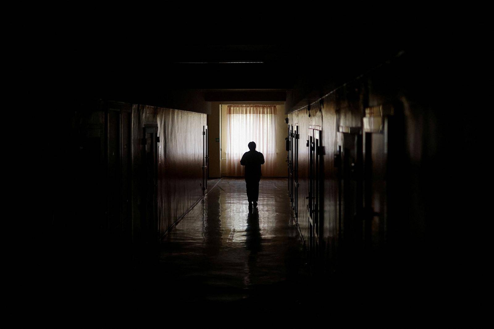 Maternity hospital employee carries to patients meals provided by the NGO World Central Kitchen during an electricity power cut in Mykolaiv