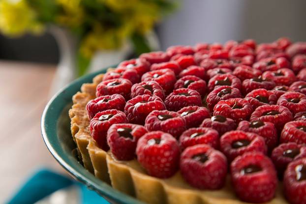 A delicious Raspberry Pie with chocolate served on a green plate
