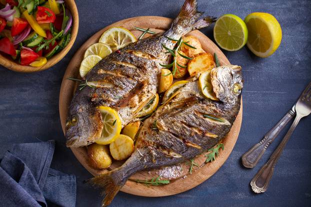 Roasted,Fish,And,Potatoes,,Served,On,Wooden,Tray.,Overhead,,Horizontal