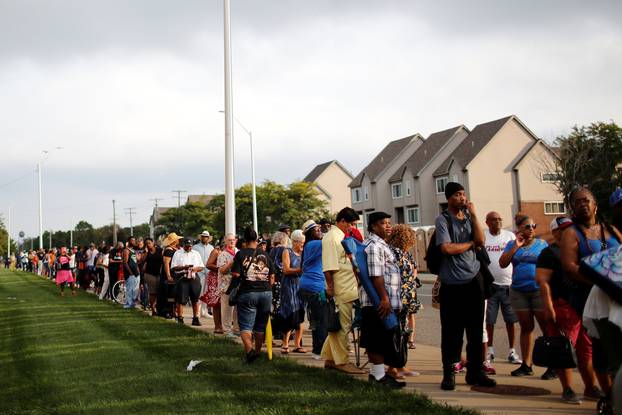 People wait in line outside the Charles H. Wright Museum of African American History for two days of public viewing of Aretha Franklin in Detroit