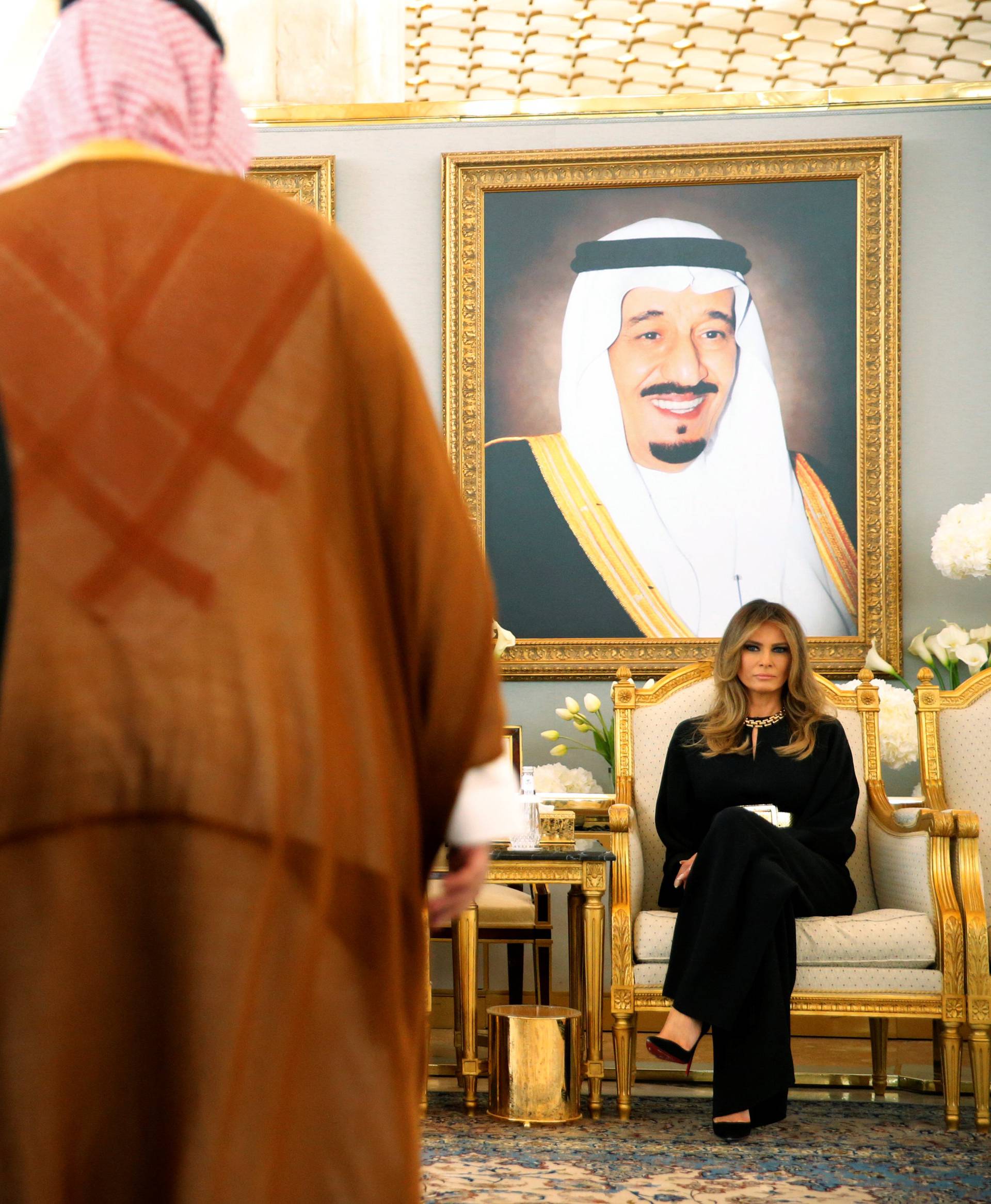 Melania Trump takes her seat next to Saudi Arabia's King Salman as he welcomes her with a coffee ceremony in the Royal Terminal in Riyadh