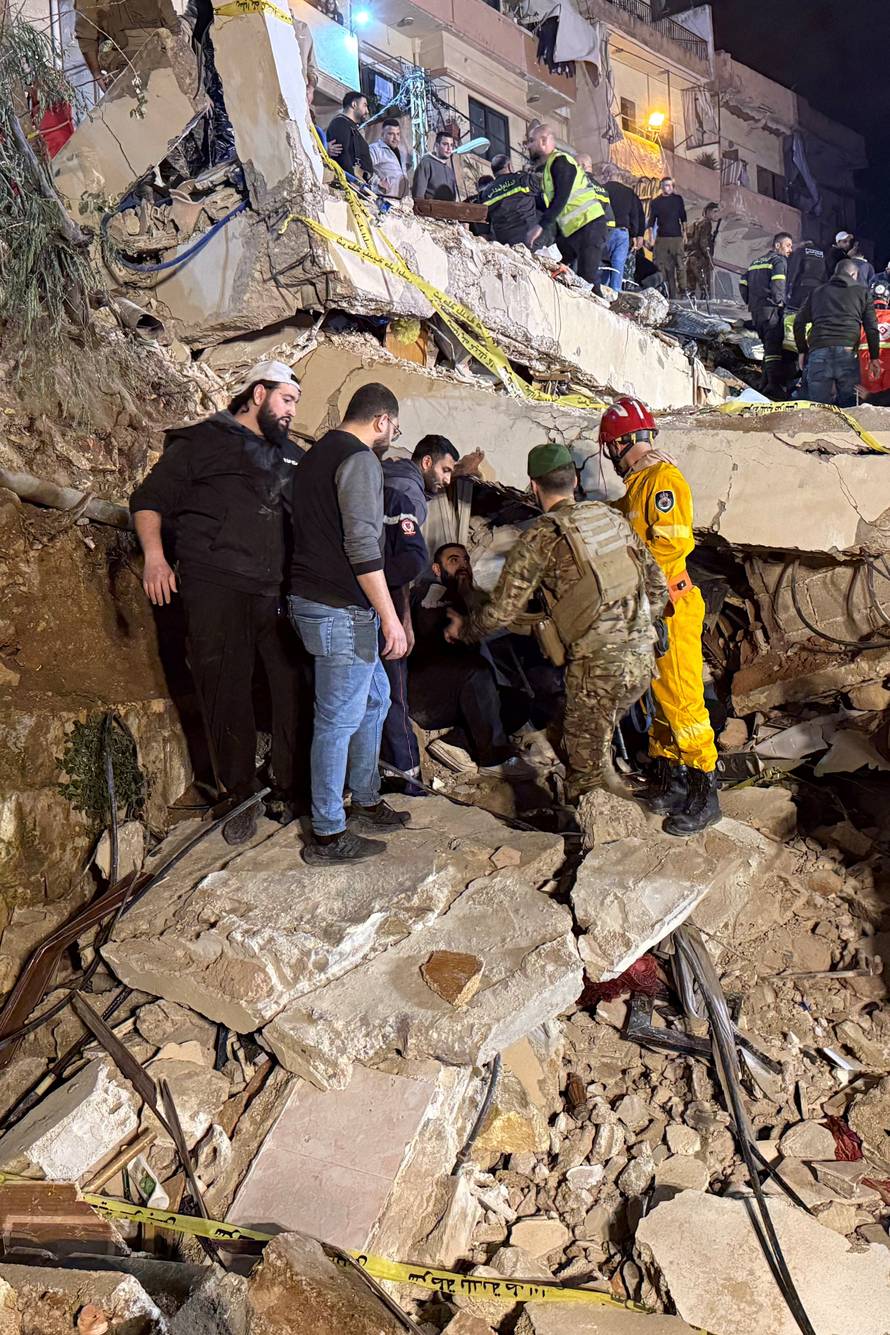 Rescue teams search for survivors after a building collapsed in Tripoli