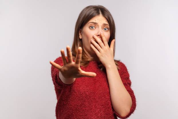 No, I'm afraid! Portrait of panicked scared girl in shaggy sweat