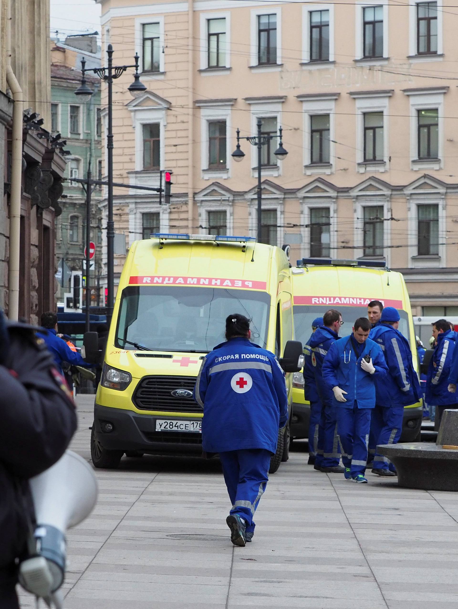 A police officer and members of the Emergency services are seen outside Tekhnologicheskiy Institut metro station in St. Petersburg