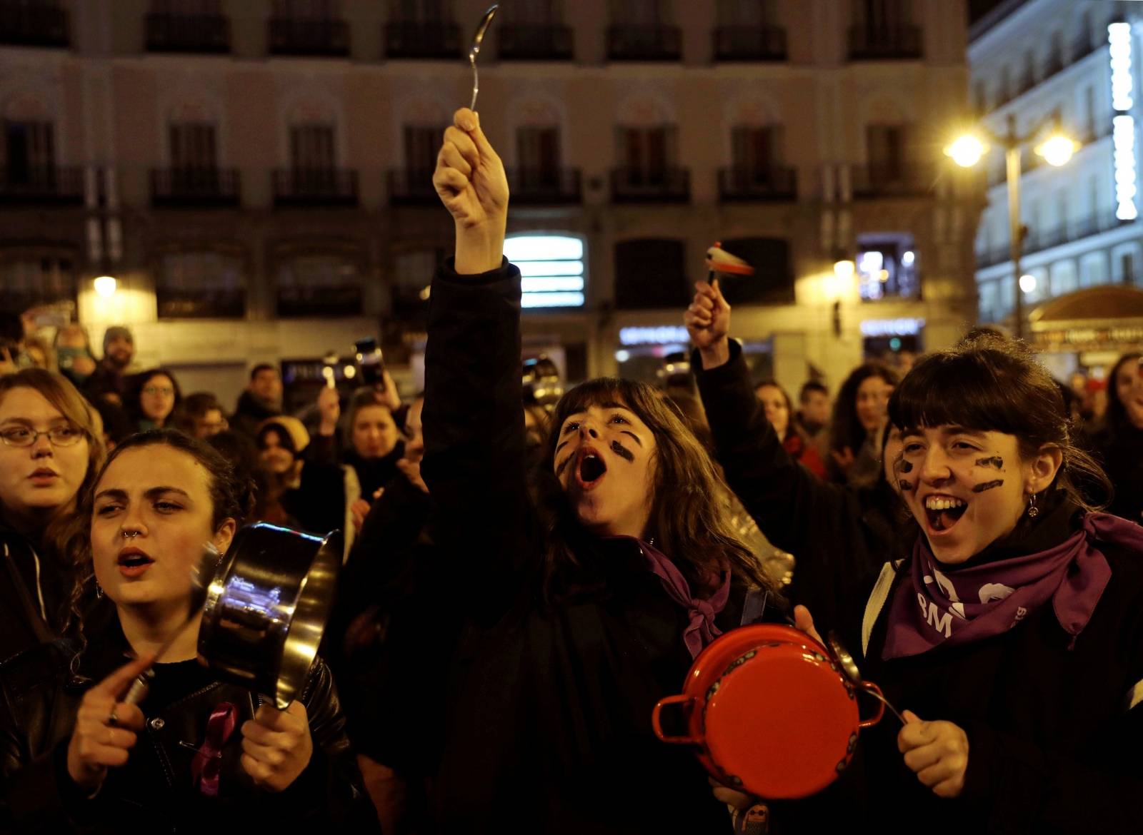 Women bang pots and pans during a protest at the start of a nationwide feminist strike on International Women's Day at Puerta del Sol Square in Madrid