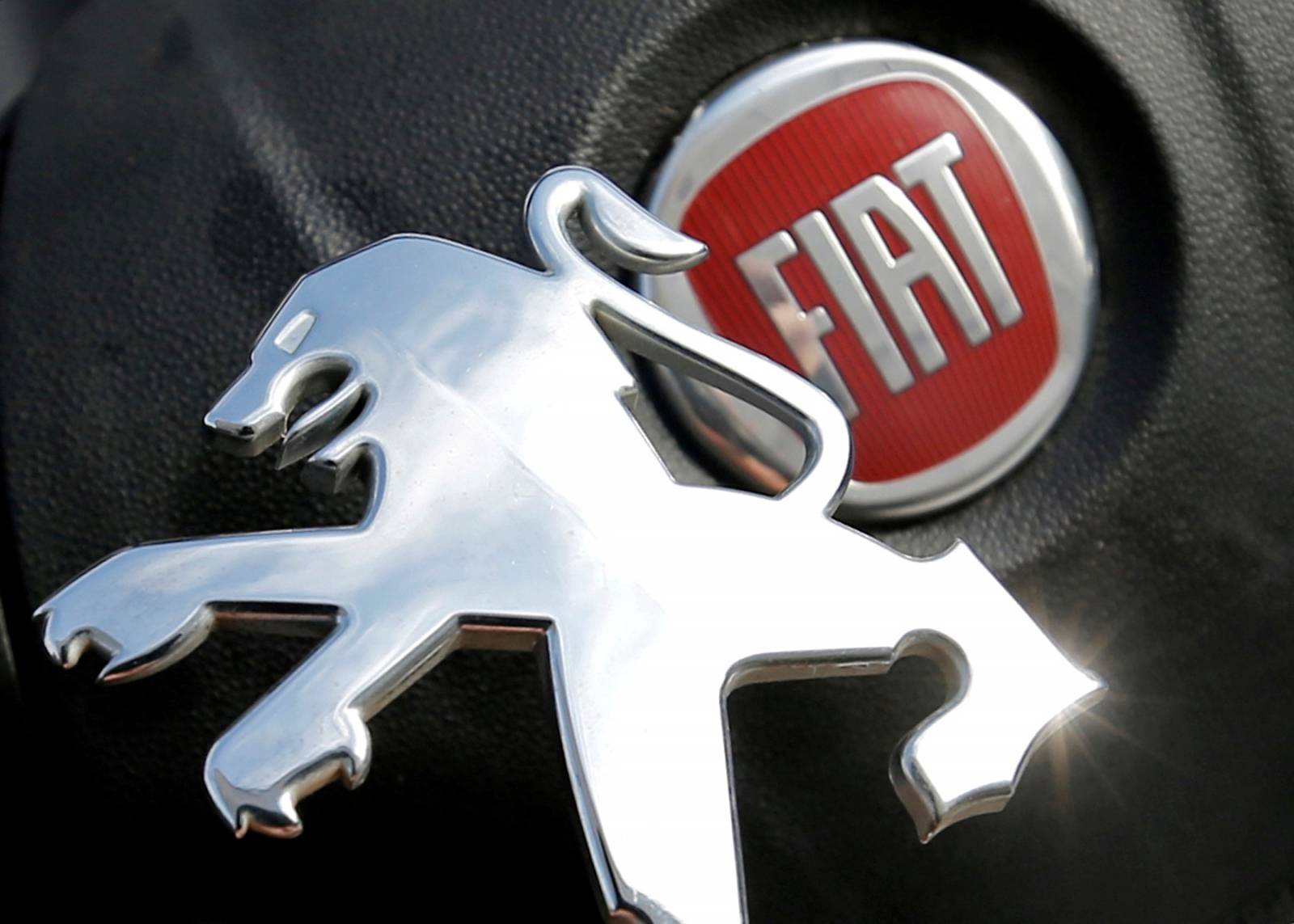 FILE PHOTO: Logos of Peugeot and Fiat are seen in this illustration picture