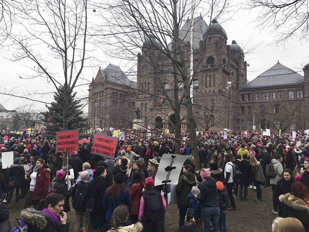 Thousands of people, many wearing pink hats, chanted, cheered and held protest signs while marching to the U.S. consulate in Toronto