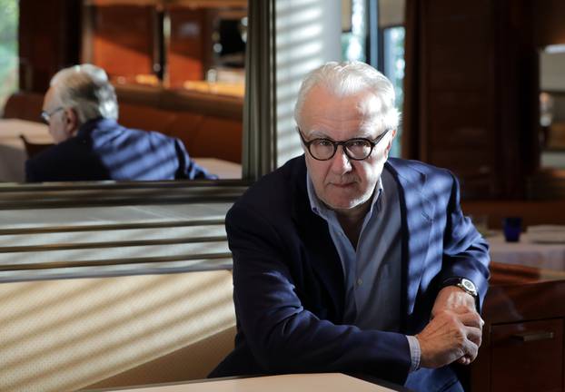 French Chef Alain Ducasse poses in his new restaurant "Omer" at the Hotel de Paris in Monte-Carlo