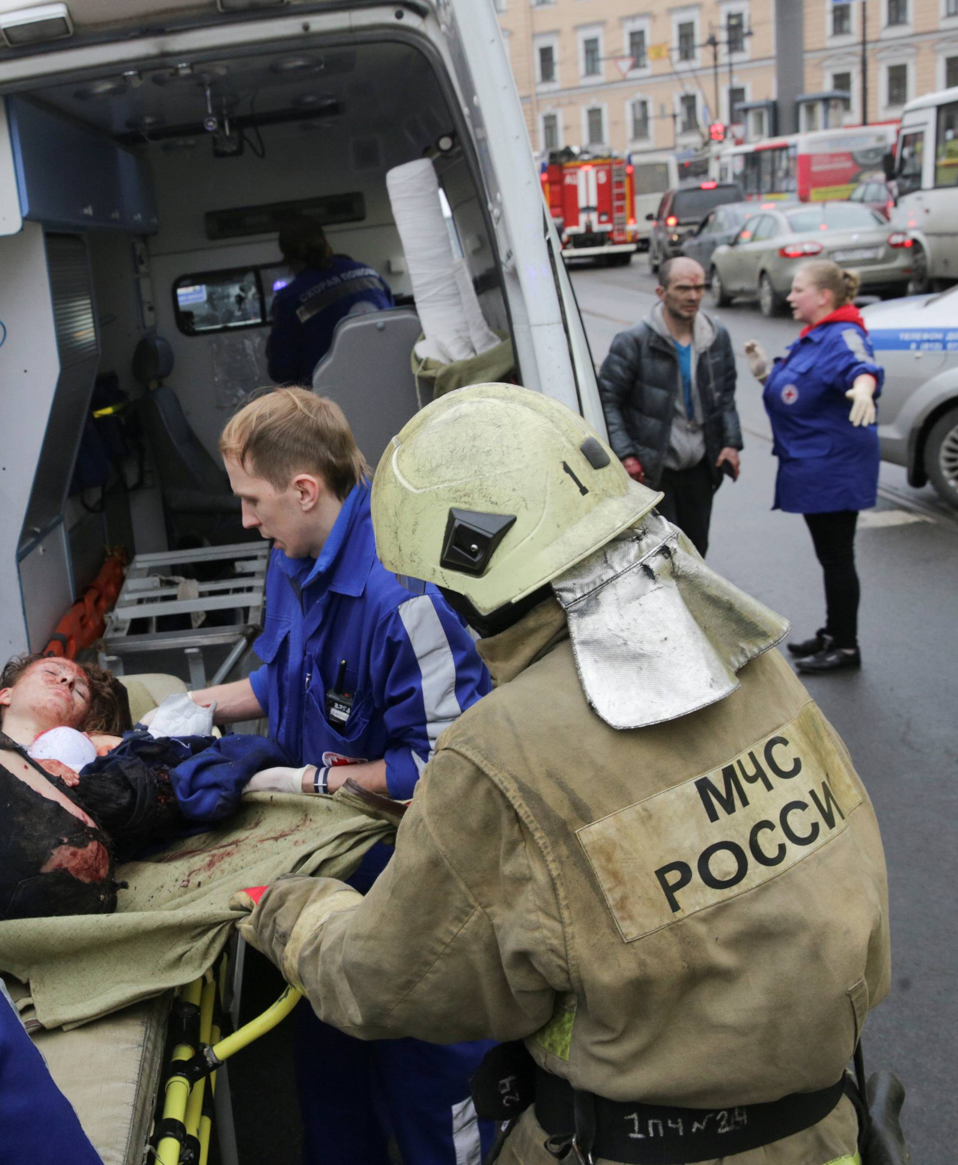 An injured person is helped by emergency services outside Sennaya Ploshchad metro station following explosions in St. Petersburg