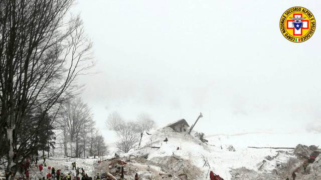 Rescue workers work with excavator at the site of the avalanche-buried Hotel Rigopiano in Farindola