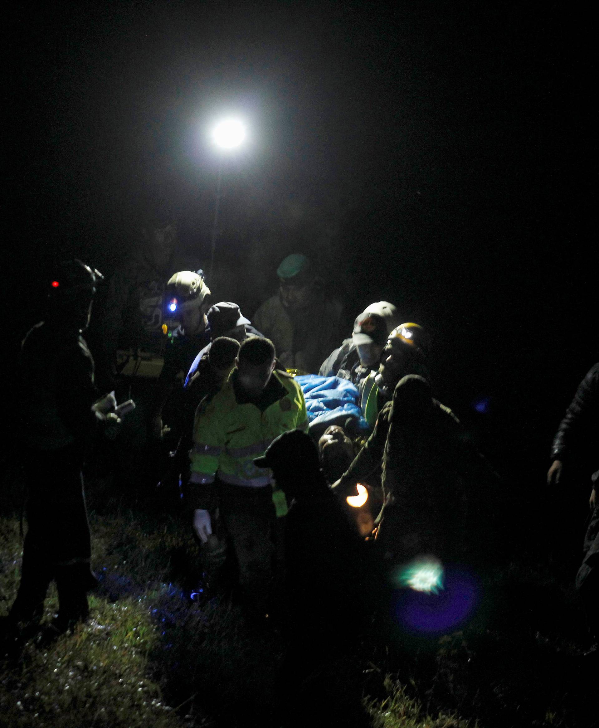 Rescue workers carry the body of a victim from a plane that crashed into Colombian jungle with Brazilian soccer team Chapecoense, is seen near Medellin