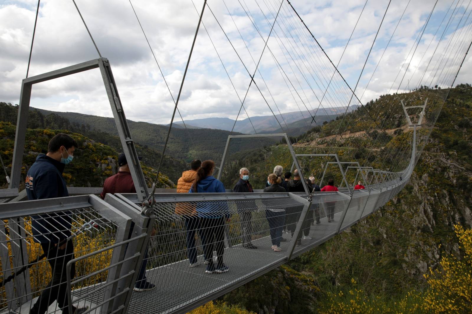 People walk on the world's longest pedestrian suspension bridge '516 Arouca', in Arouca