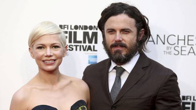 Actors Michelle Williams and Casey Affleck pose for photographers at a Gala screening of their film "Manchester by the Sea" at the 60th BFI London Film Festival in London