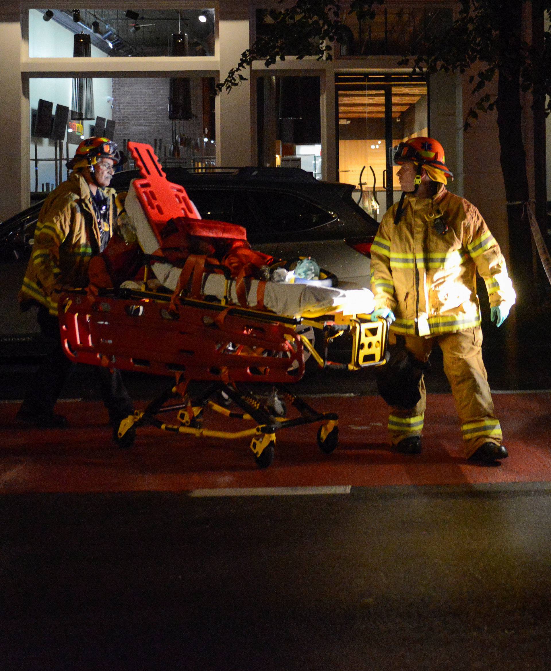 New York City firefighters use wheeled stretcher to carry supplies near site of explosion in New York