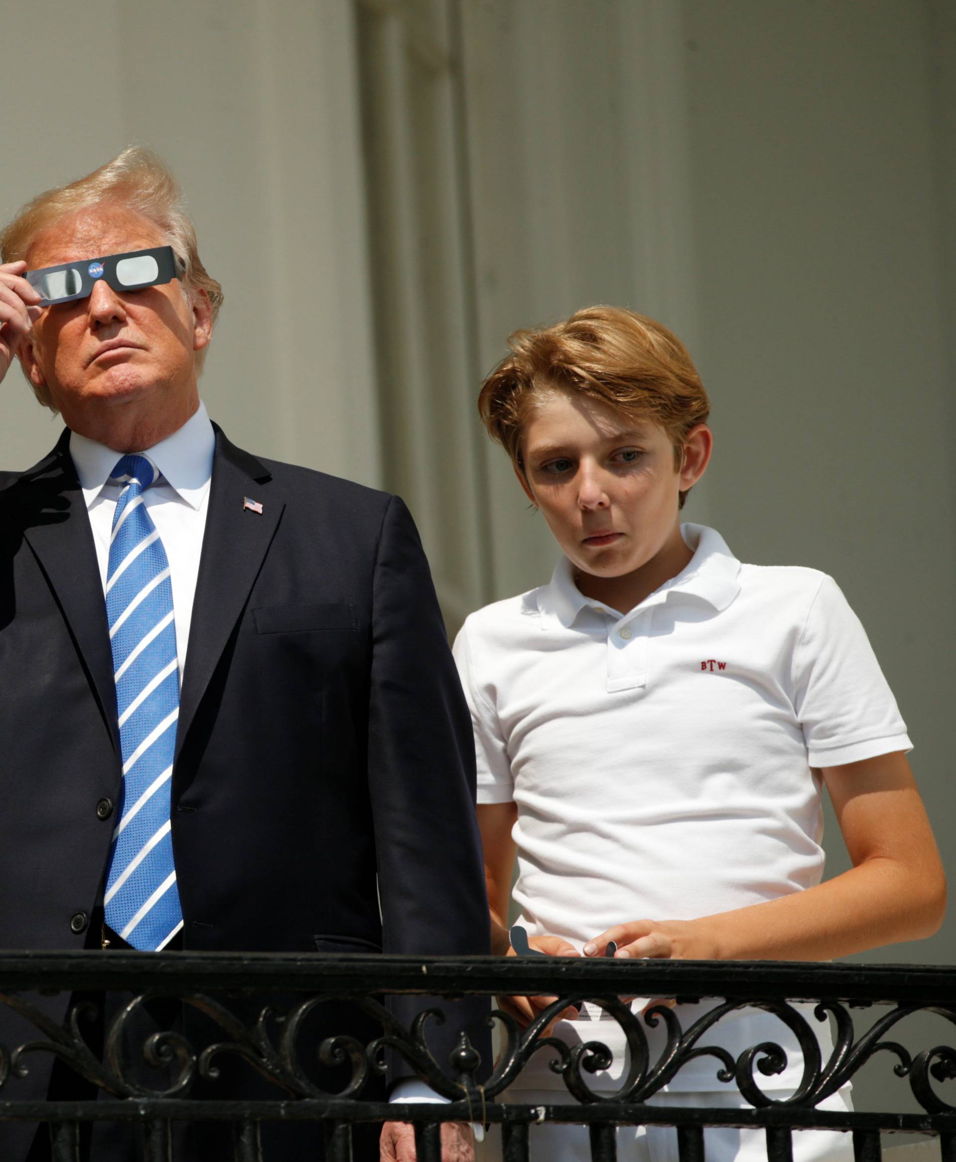U.S. President Trump watches the solar eclipse with first Lady Melania Trump and son Barron from the Truman Balcony at the White House in Washington