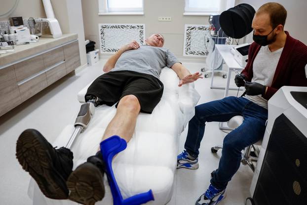 Former Ukrainian serviceman, who was wounded at a front line, comes to a clinic to treat scars, in Kyiv