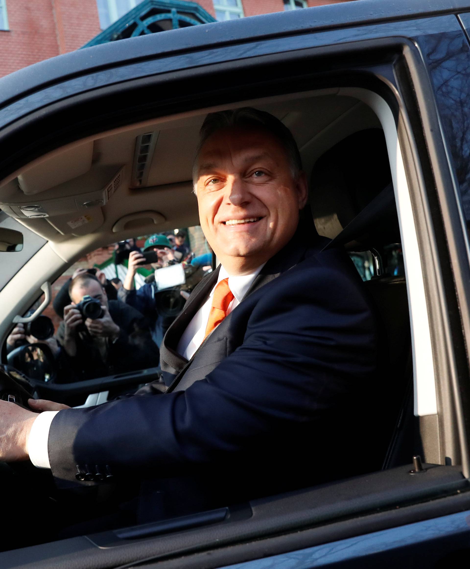 Current Hungarian Prime Minister Viktor Orban smiles to the media from his car after leaving a polling station during Hungarian parliamentary election in Budapest