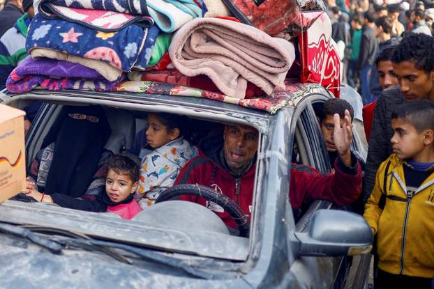 A displaced Palestinian man gestures from a car loaded with belongings following a delay in the ceasefire between Israel and Hamas over the hostage list, in Khan Younis in the southern Gaza Strip