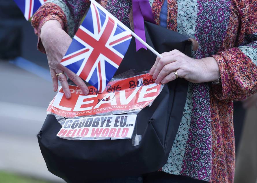 A vote leave supporter holds a poster in Westminster, London