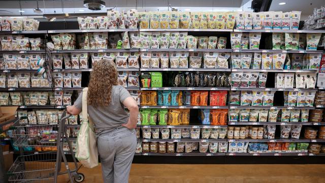 FILE PHOTO: A person shops in a supermarket as inflation affected consumer prices in Manhattan, New York City