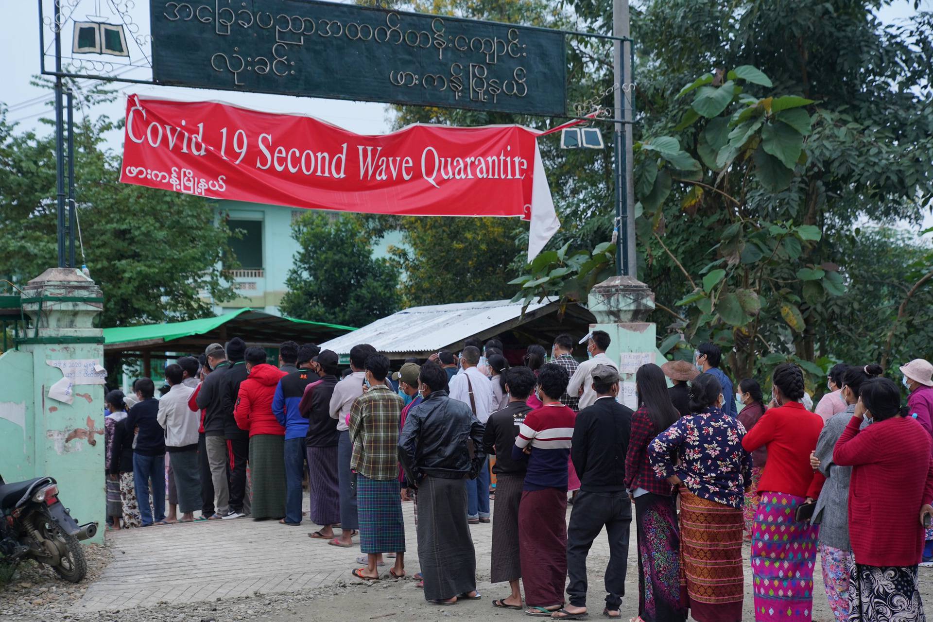 Poeple wait in line before voting during the general election at a polling station in Kachin State, Myanmar