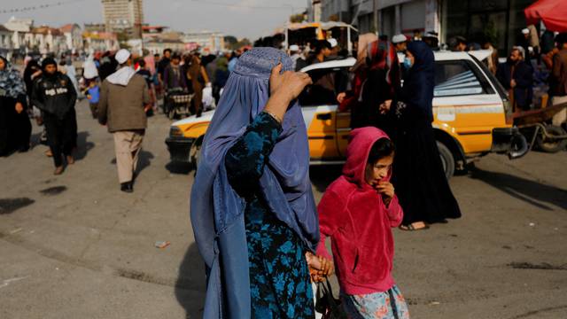 FILE PHOTO: An Afghan woman and a girl walk in a street in Kabul