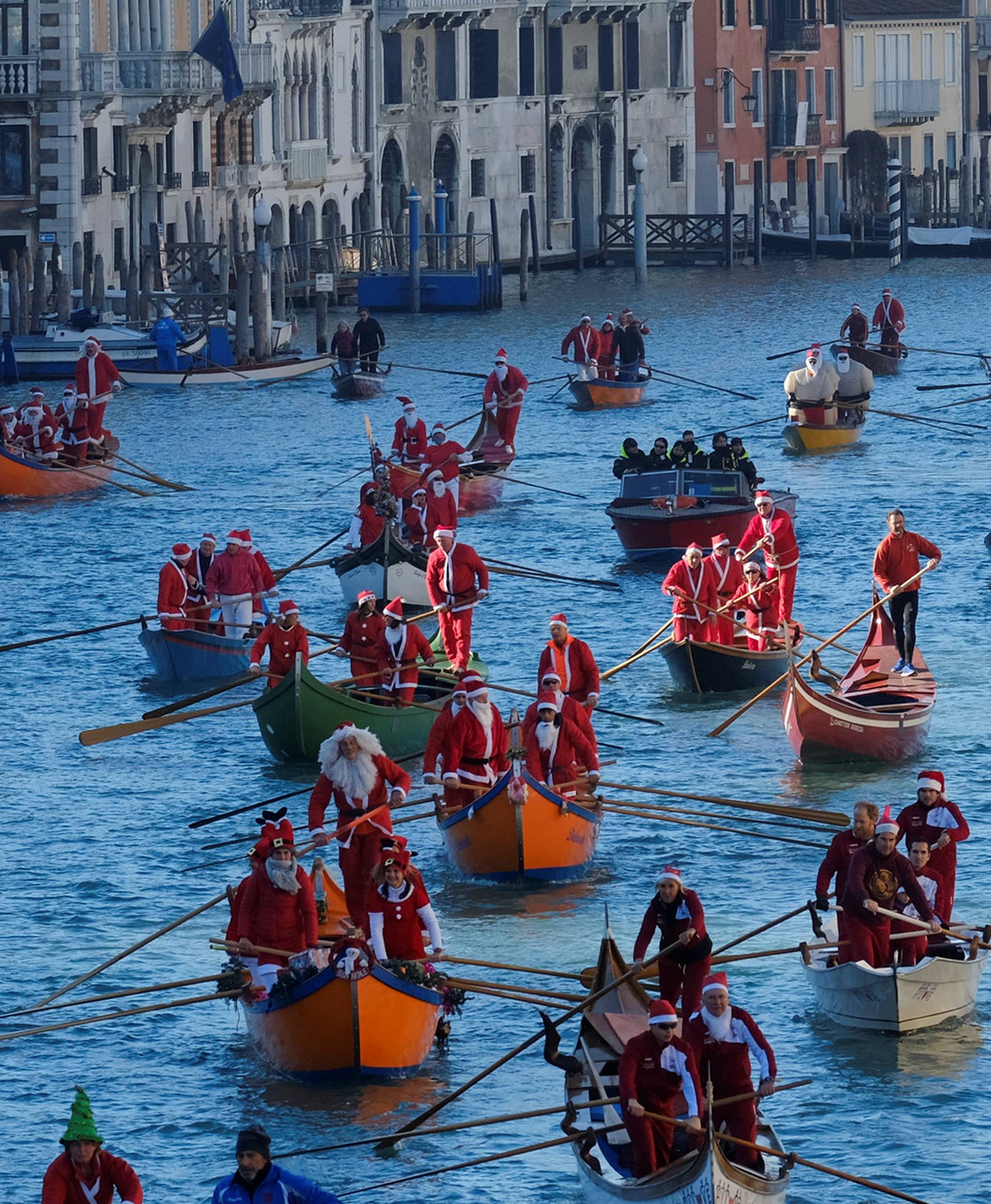 People dressed as Santa Claus row during a Christmas regatta in Venice