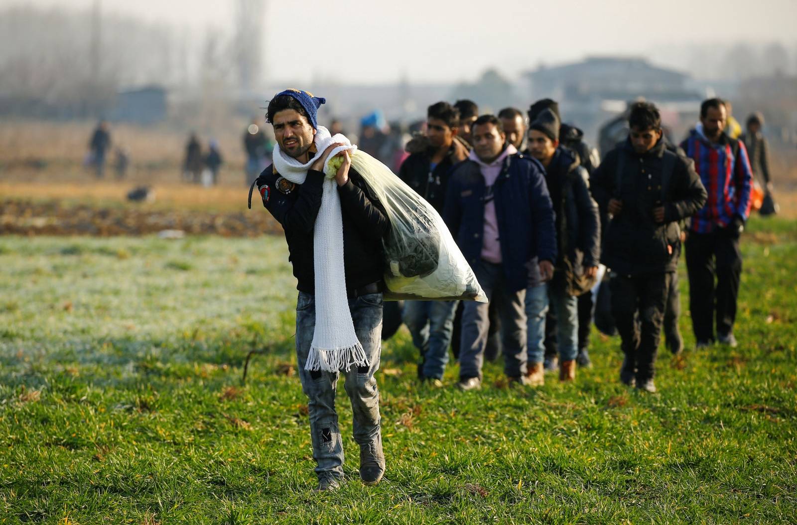 Migrants walk towards the Turkey's Pazarkule border crossing with Greece's Kastanies, near Edirne