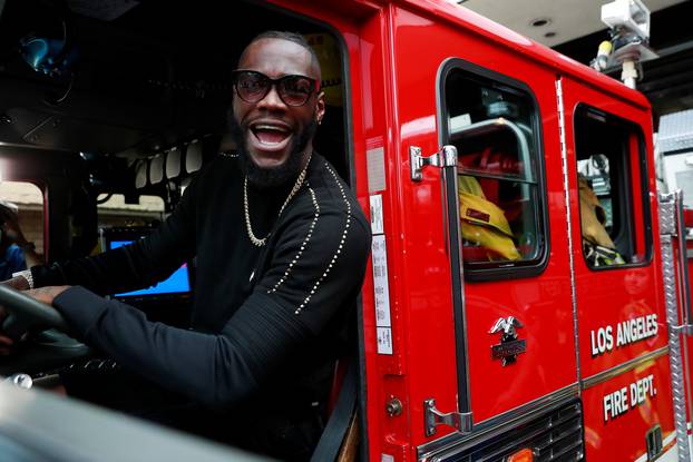 Deontay Wilder presents tickets to LA firefighters ahead of his WBC heavyweight title fight with Tyson Fury