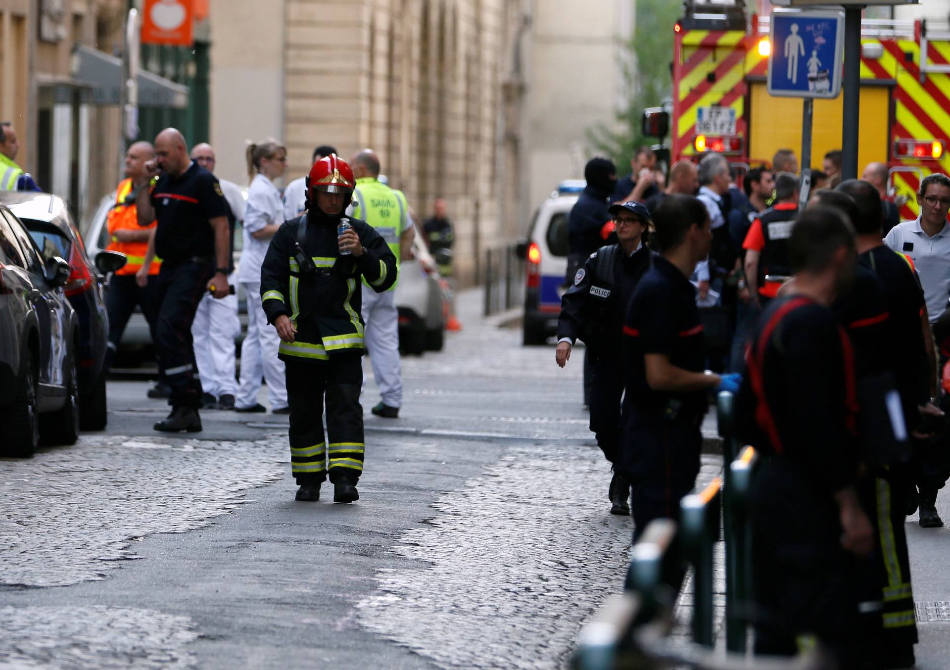 Fire fighters and medics are seen near the site of a suspected bomb attack in central Lyon