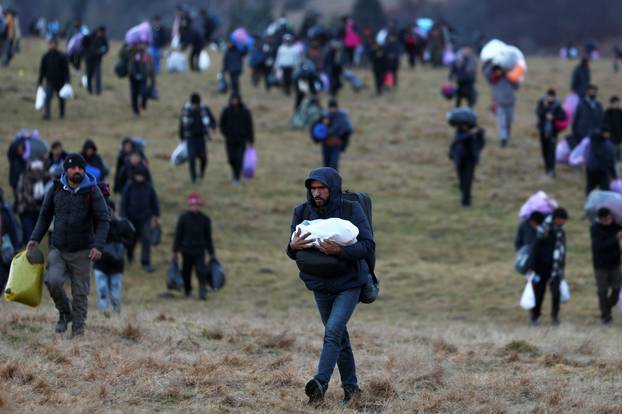 Migrants walk towards the forest after camp "Lipa" was closed, in Bihac