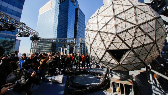 Media try to take a look of the Waterford Crystal triangles on the Times Square New Year's Eve Ball on the roof of One Times Square in the Manhattan borough of New York