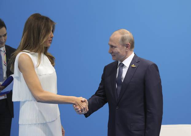 Russian President Vladimir Putin shakes hands with U.S. First Lady Melania Trump during a meeting on the sidelines of the G20 summit in Hamburg