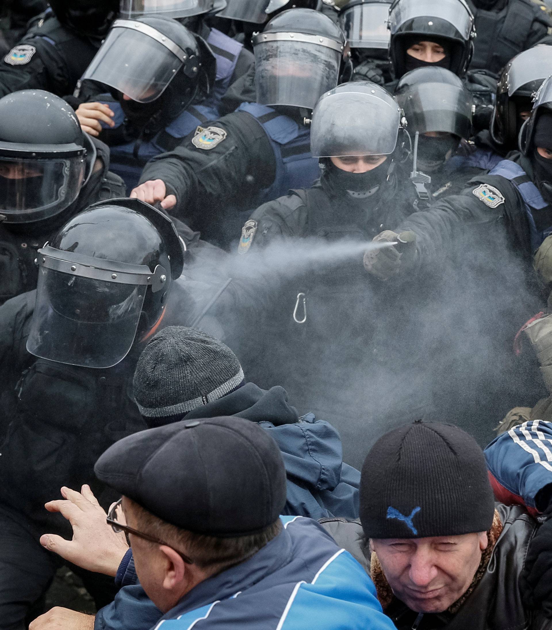 Police officers use tear gas against supporters of former Georgian President Saakashvili during clashes in Kiev