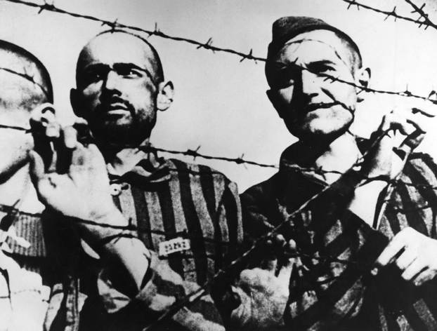 Prisoners behind barbed wire in a concentration camp, WW2