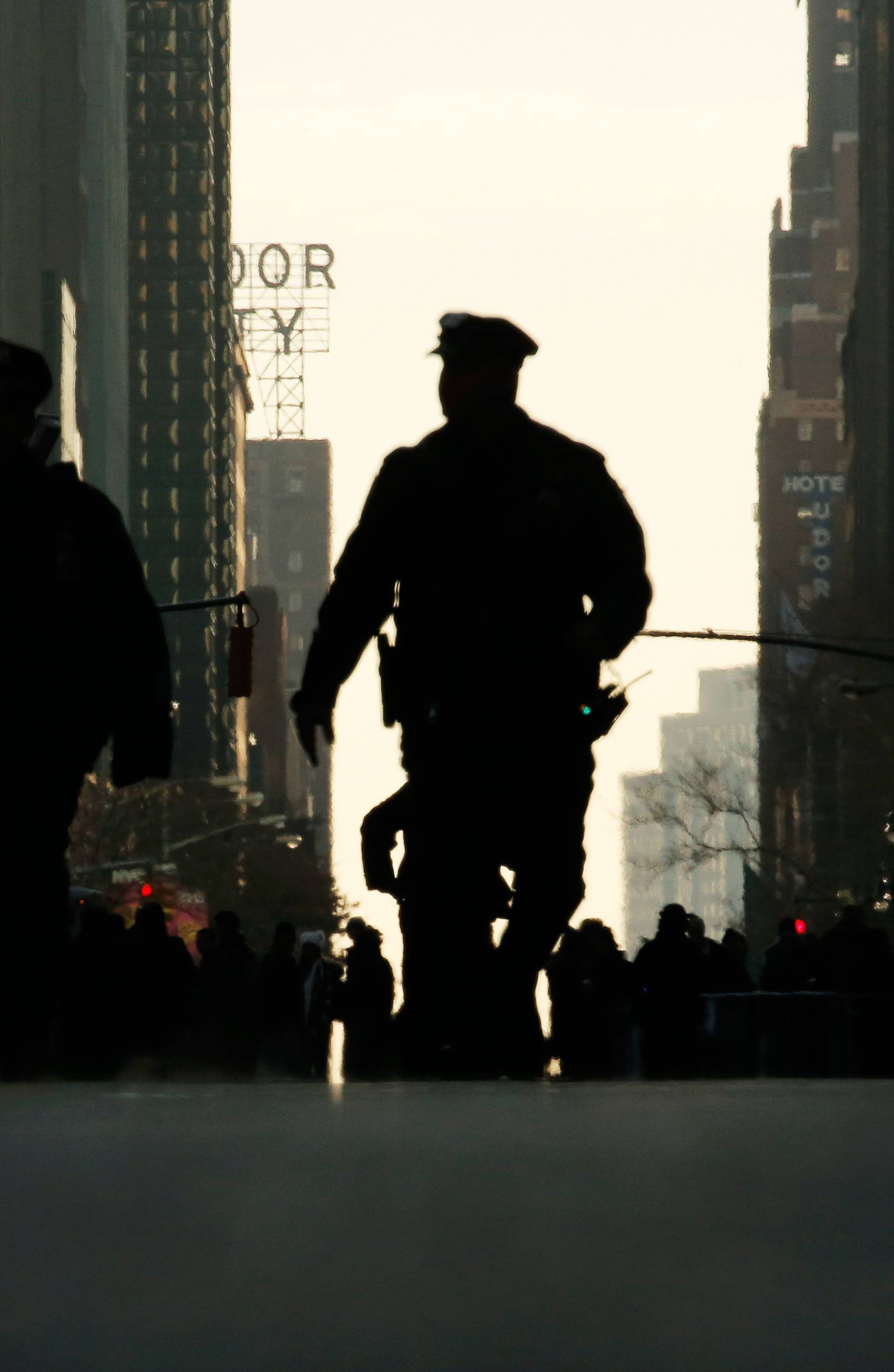 A police officer walks down the street outside the New York Port Authority Bus Terminal in New York City after reports of an explosion.