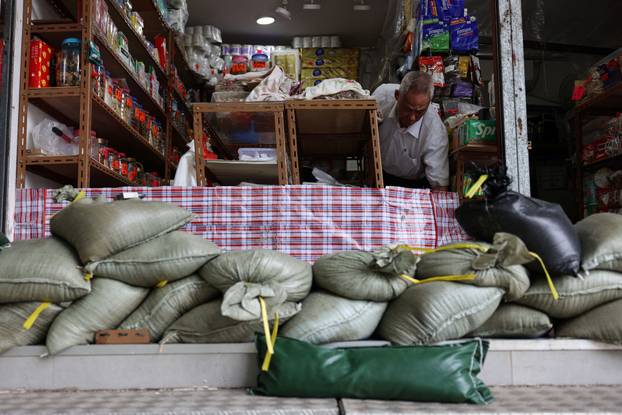 Sand bags are placed in front of a store in preparation for Super Typhoon Ragasa, in Hong Kong