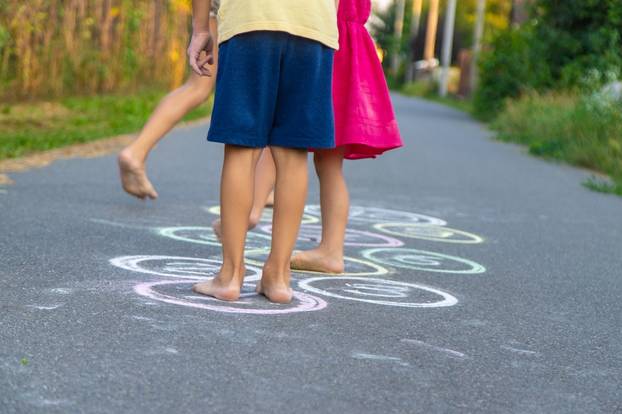 Children,Play,A,Classic,Game,On,The,Asphalt.,Selective,Focus.