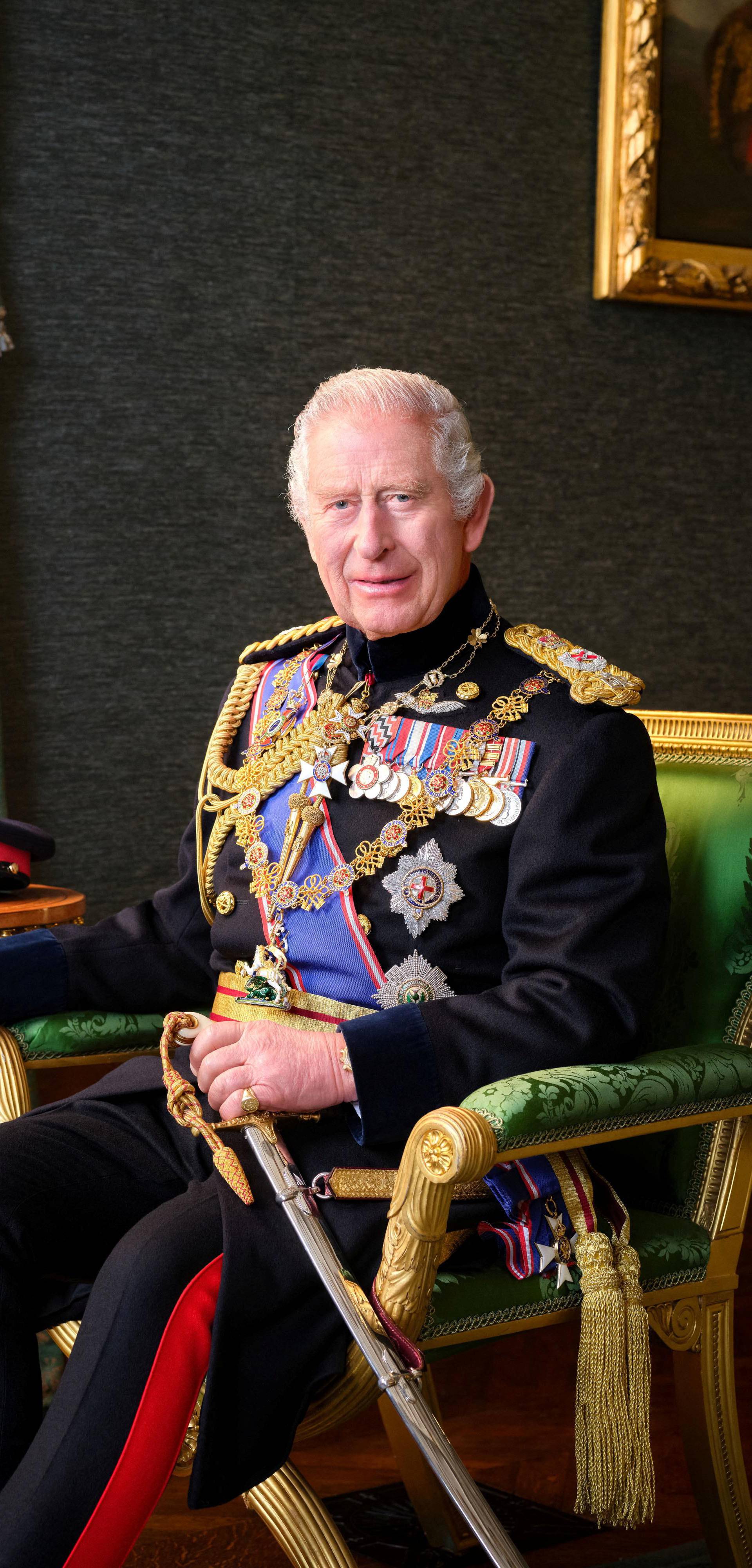 Britain's King Charles poses for a picture while wearing his Field Marshal No1 Full Ceremonial Frock Coat with medals, sword and decorations, in this undated handout picture