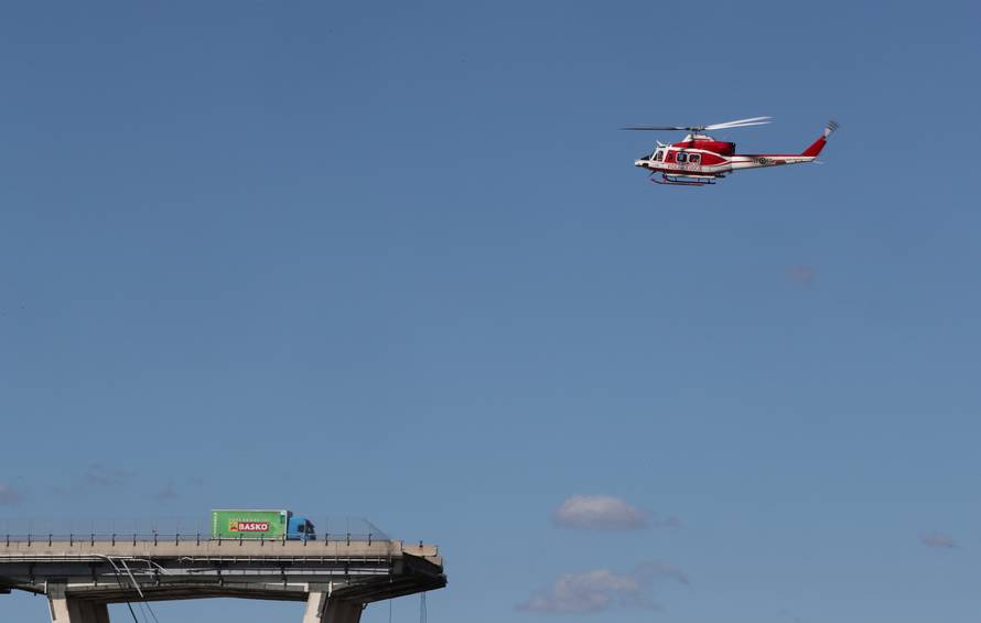 Firefighter helicopter flies over the collapsed Morandi Bridge in the Italian port city of Genoa