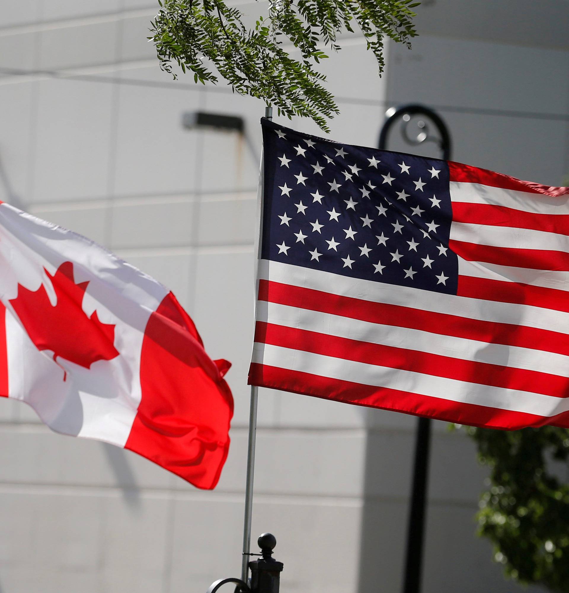 FILE PHOTO: Flags of the U.S., Canada and Mexico fly next to each other in Detroit, Michigan