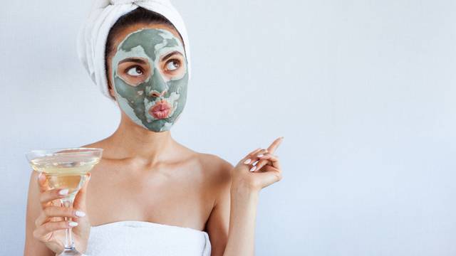 Young beautiful woman in face mask of therapeutic blue mud. Spa 