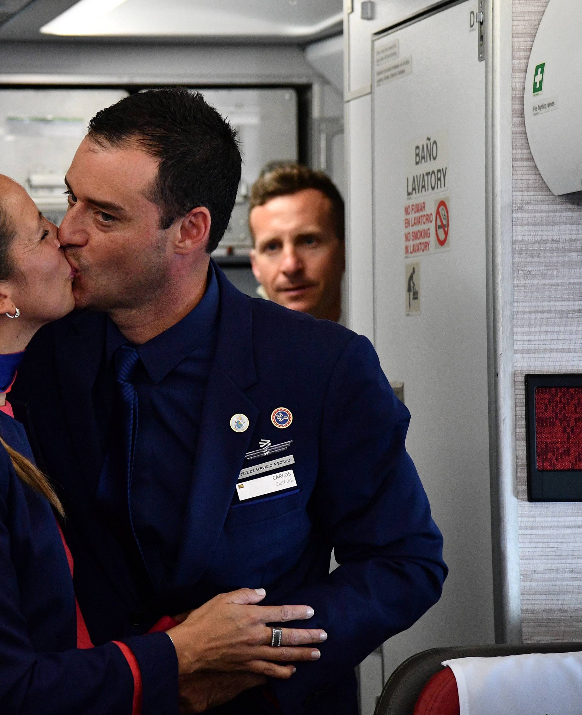 Crew members Paula Podest and Carlos Ciufffardi kiss after being married on board by Pope Francis during the flight between Santiago and the northern city of Iquique