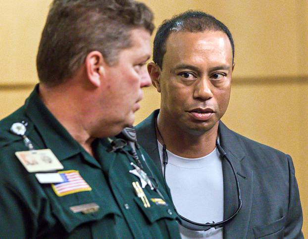 Golfer Woods leaves Palm Beach County court after he pleaded guilty to a charge of reckless driving in Palm Beach
